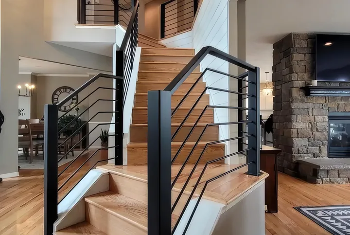 Stairs inside a home with a cable railing